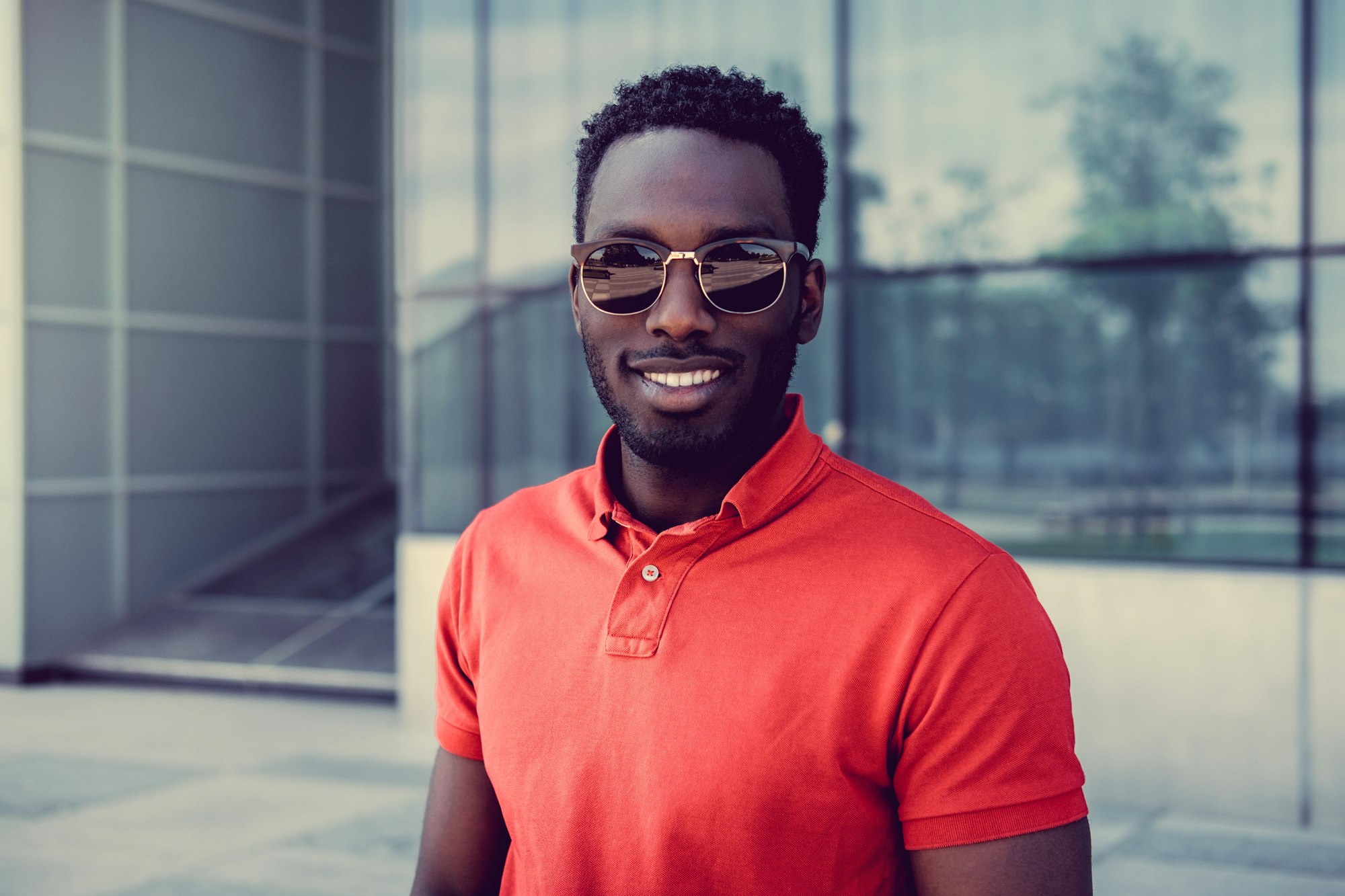 Smiling African American male in sunglasses.